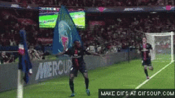 a soccer player celebrates after scoring a goal in front of a banner that says mercure