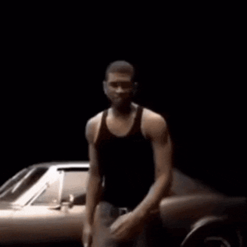 a man is dancing in front of a car .