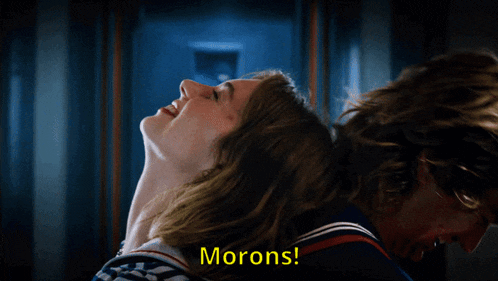a close up of a man and a woman with the words morons written below them