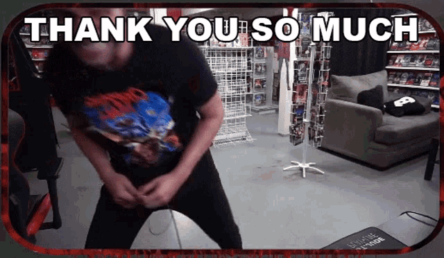 a man in a black shirt is dancing in front of a thank you so much sign