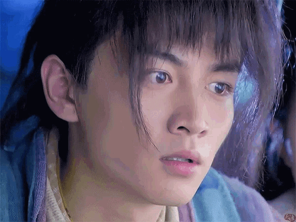 a close up of a man 's face with a blue background and chinese writing