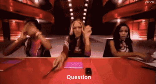 three women are sitting at a table and the word question is on the screen
