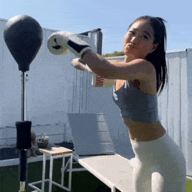 a woman is wearing boxing gloves that say king