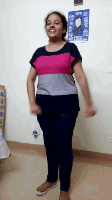 a woman is dancing in front of a poster that says " i laugh when i laugh "