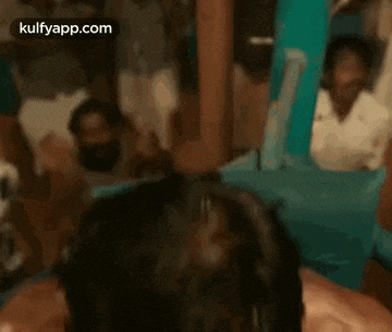 a man with blood on his face is laying in a boxing ring with a rope around his neck .