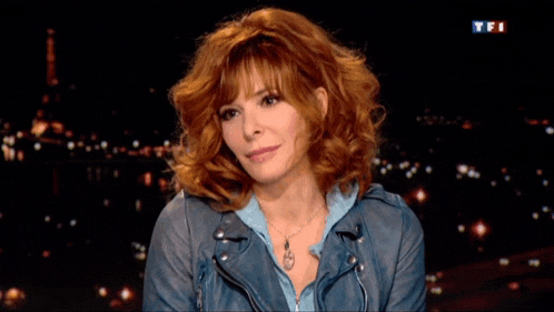 a woman with red hair is on a tv show with the letters tfi