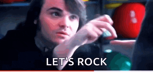 a man is sitting in front of a computer with the words let 's rock written on the bottom .