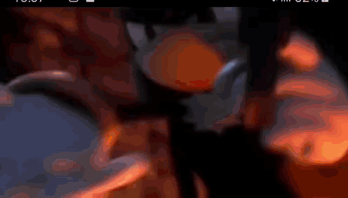 a close up of a person holding a lighter in their hand with a flame coming out of it .