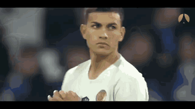 a man in a white shirt is clapping his hands