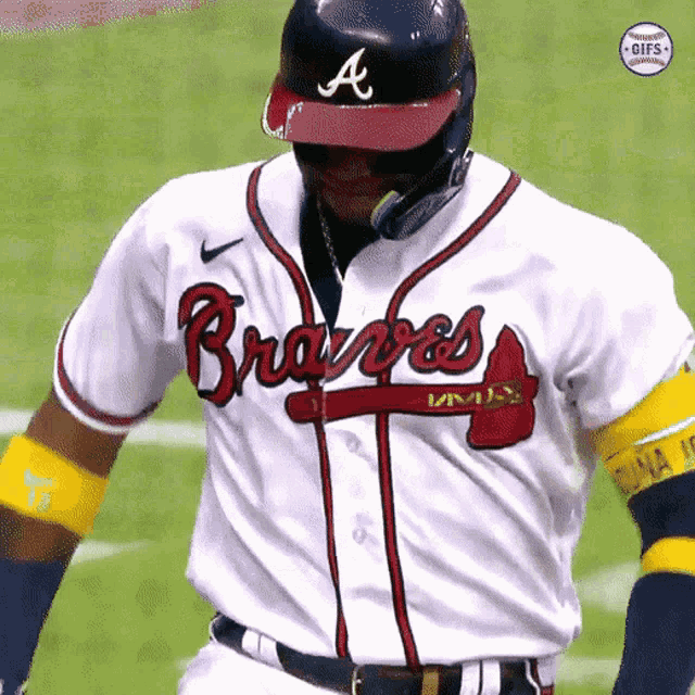 a baseball player wearing a braves jersey and helmet