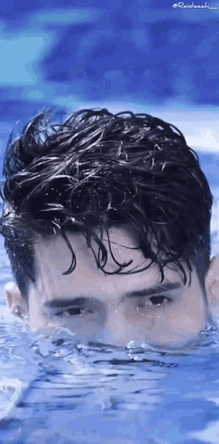 a close up of a man swimming in a pool