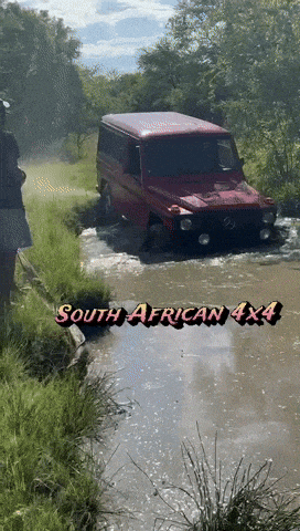 a south african 4x4 driving through a muddy stream