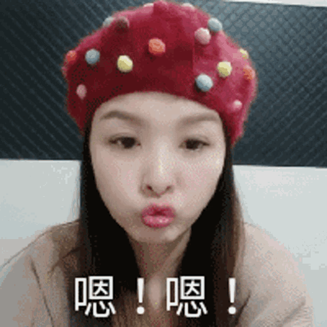 a woman wearing a red hat with colorful polka dots on it