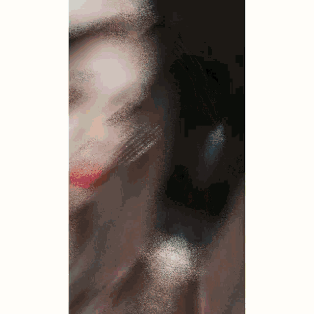 a close up of a woman 's face with a dark background