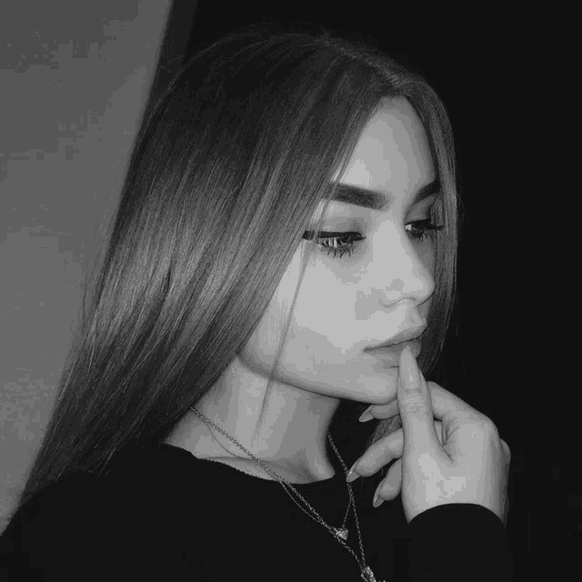 a black and white photo of a woman 's face