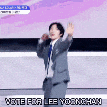 a man in a suit and tie is dancing with the words vote for lee yoonchan above him
