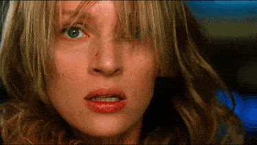 a close up of a woman 's face with red lips