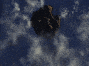 a large rock in the sky with clouds surrounding it