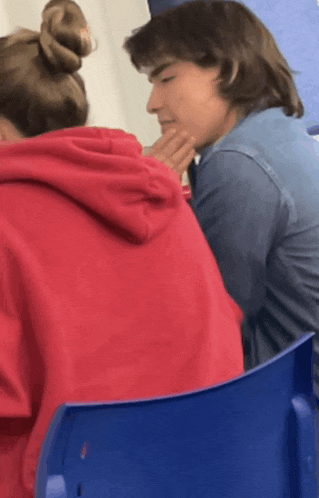 a man and a woman are sitting next to each other