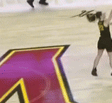 a hockey player is holding a puck in front of a large a on the ice