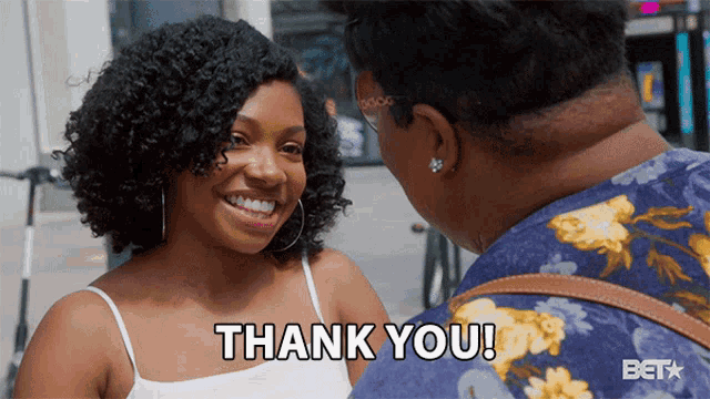 a woman says thank you to another woman while smiling