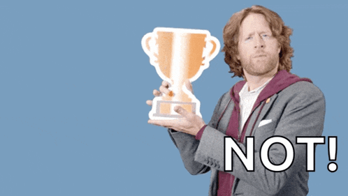 a man holding a trophy with the words " you deserve a trophy not " behind him