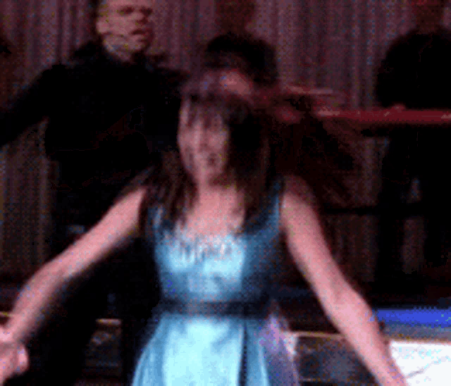 a blurry picture of a woman in a blue dress