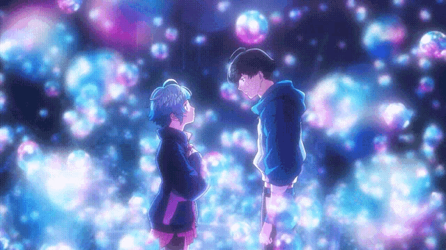 a boy and a girl are standing next to each other in front of bubbles
