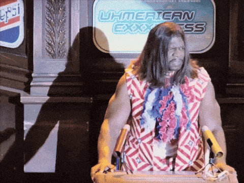 a man stands at a podium in front of a sign that says uh american express