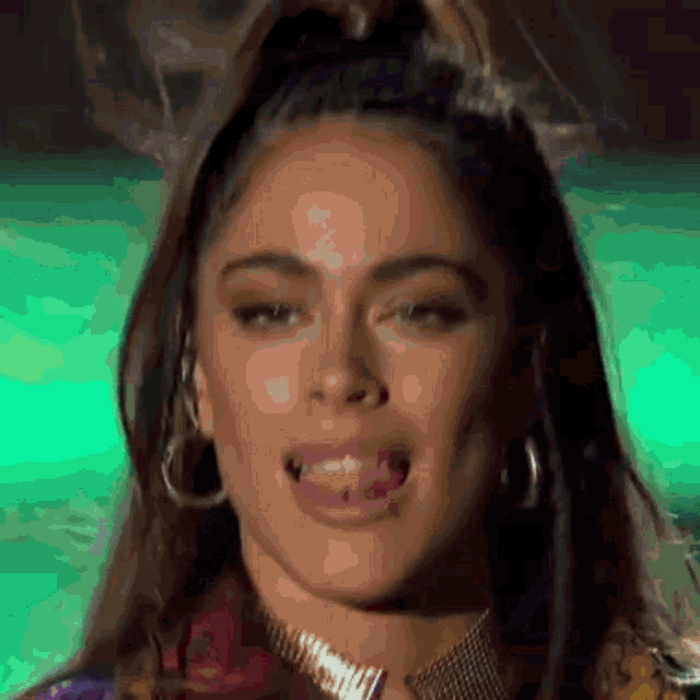 a close up of a woman 's face with her tongue sticking out