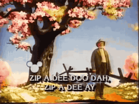 a man standing in front of a tree with pink flowers and the words zip a dee doo dah