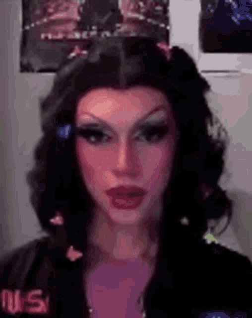 a close up of a woman wearing a wig and butterfly hair clip .