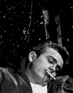 a black and white photo of a man sleeping with his eyes closed .