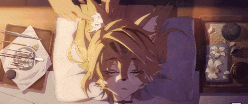 a fox laying on a bed with its eyes closed getting a massage