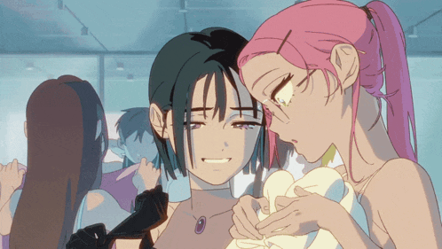 a girl with pink hair is hugging a girl with black hair