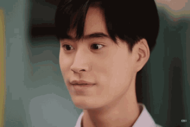 a close up of a young man 's face looking at the camera