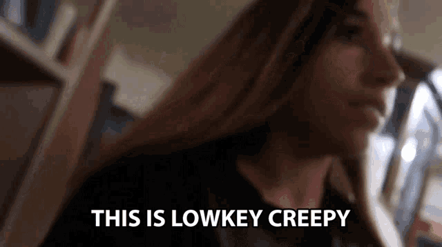 a woman with long hair is saying this is lowkey creepy in a blurry photo .