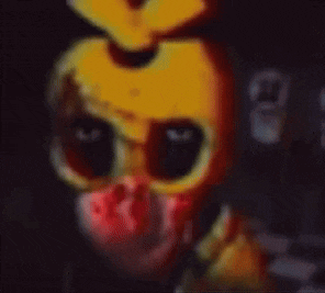 a close up of a yellow and red cartoon character with blood on his face .