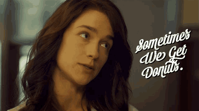 a woman 's face is shown with the words sometimes we get donuts behind her
