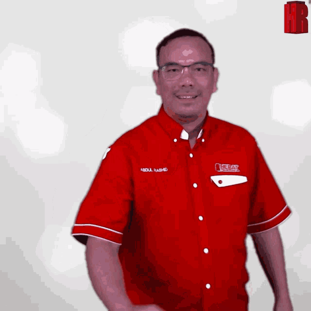 a man wearing a red shirt that says abdul yahid