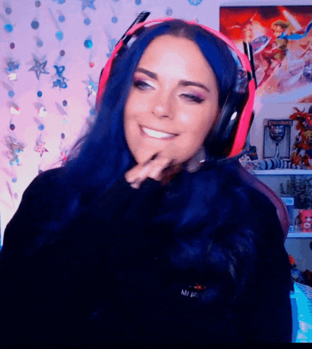 a woman with blue hair is wearing headphones and a black shirt that says mi