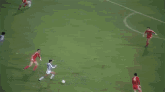 a soccer field with coca cola advertisements on the fence