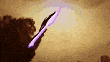 a person holding a purple knife in their hand