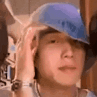a man is wearing a blue hat on his head .