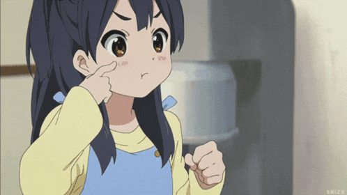 a girl with a yellow shirt and blue apron is pointing her finger at her nose