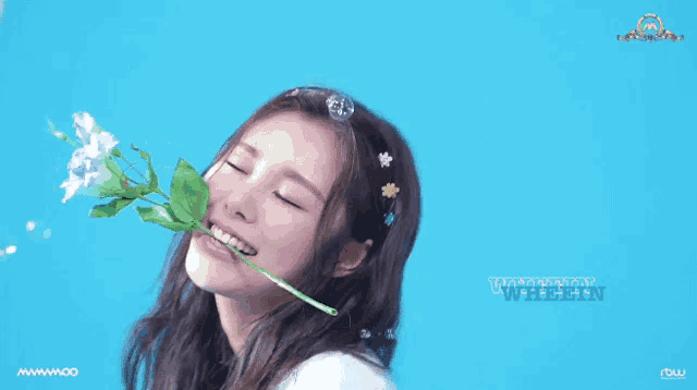 a woman holding a flower in her mouth with the word whalein written on the bottom