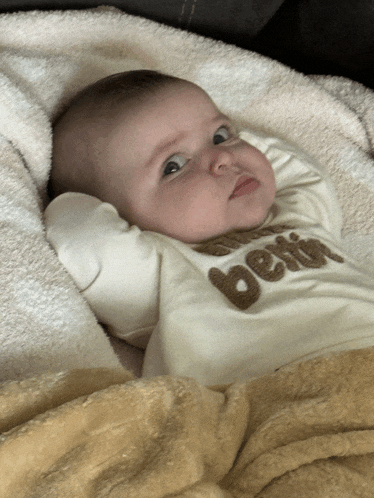 a baby wearing a shirt that says " better "