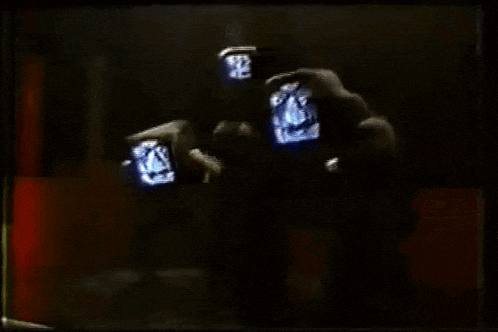 a person is holding a cell phone with a face on the screen