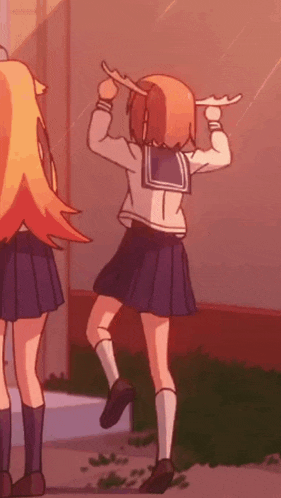 a girl in a school uniform is holding a stick in her hand while dancing .