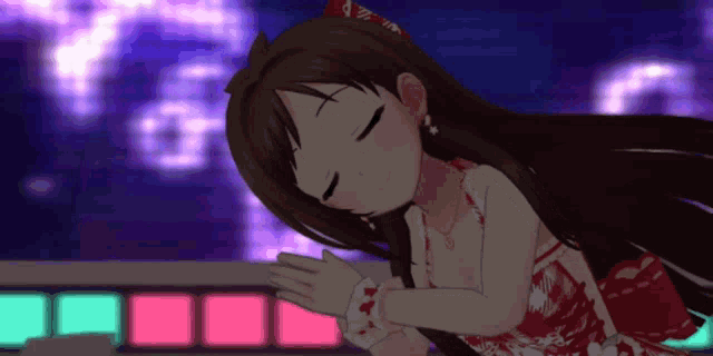 a girl in a red dress with a bow on her head is sleeping with her eyes closed